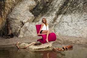 Beautiful Sexy female Model posing on red chair