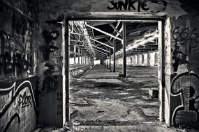 Black and white landscape of the old train hall, with the construction and graffities