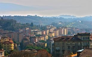 Beautiful landscape with the colorful houses and green plants, on the green mountains, in light