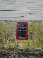 Red window of the old wooden barn