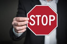 hand man stop road sign