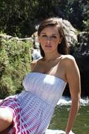 photo of a beautiful girl on the shore of a pond
