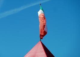italy flag on the spire of a building close up