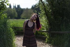 sexy Girl with purple hair posing in park