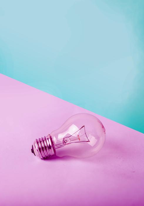 Beautiful light bulb on the pin surface at blue and green background
