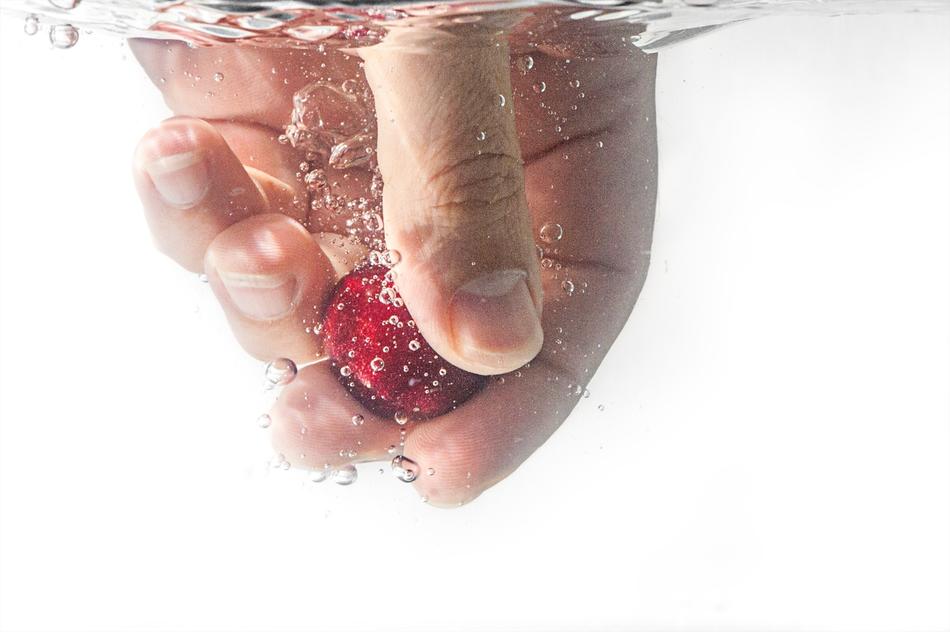 People Hand with berry in Water