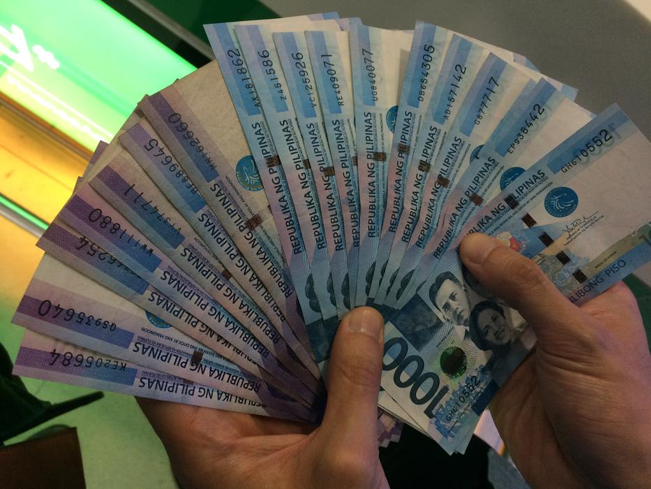 Person Holding Banknotes Of Philippines In The Hands Free Image Download