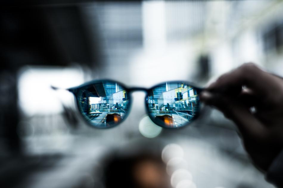 Close-up of the colorful and beautiful eyeglass in the hand, at bokeh background