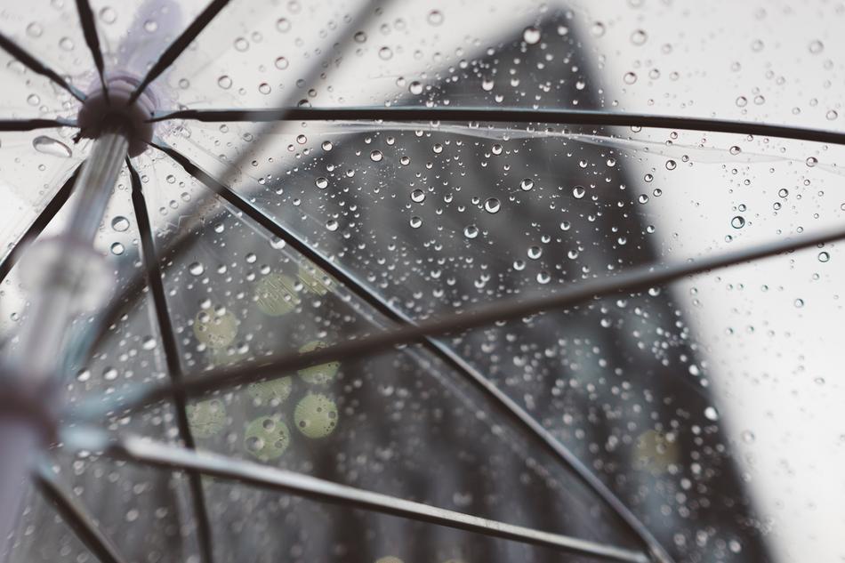 Beautiful rain drops on the transparent plastic umbrella