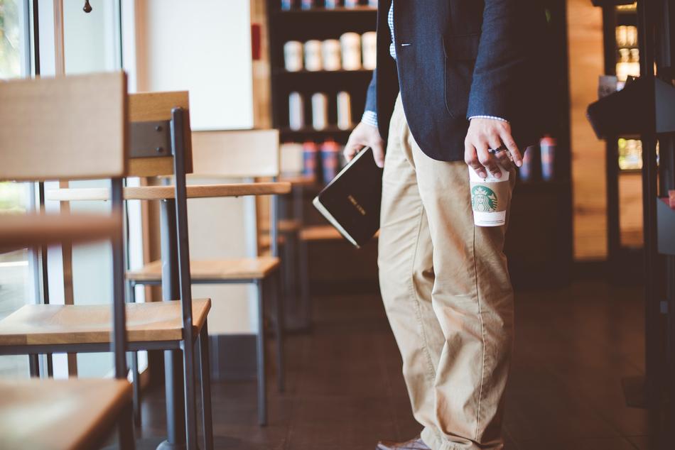 man with book and coffe
