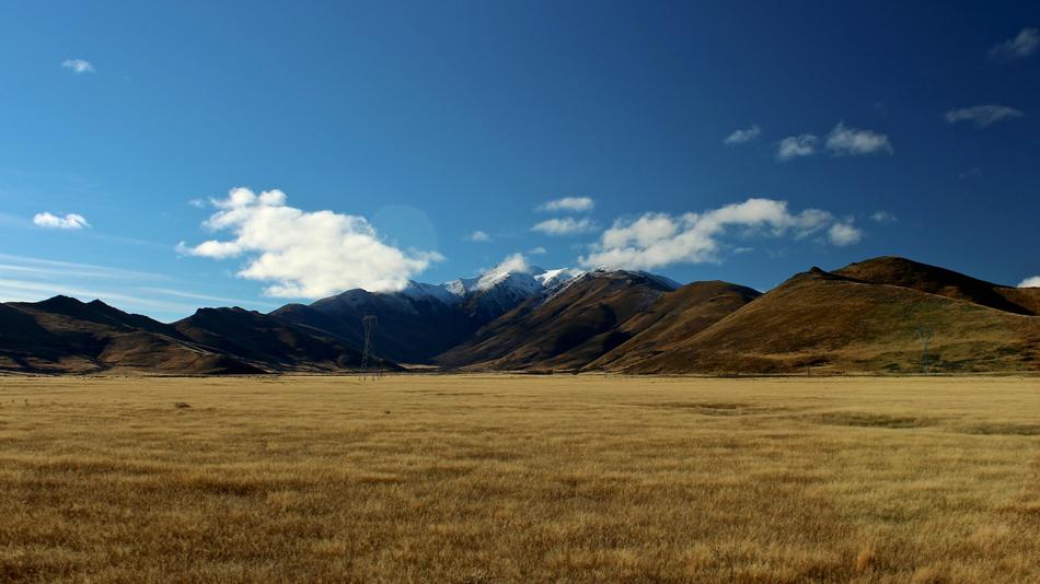 high mountains on the background of a dry field