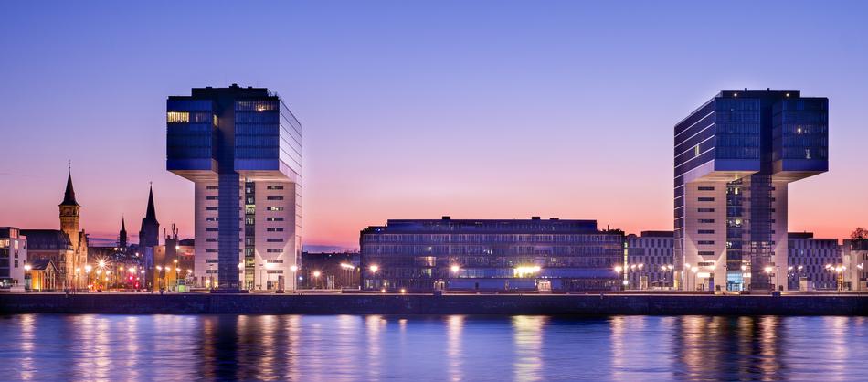 Beautiful cityscape with the coast with colorful lights at colorful sky background