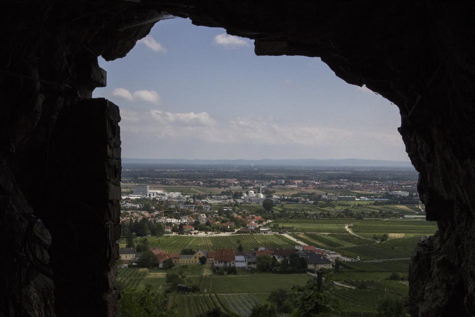 Beautiful view of the city and green fields, through the rocks