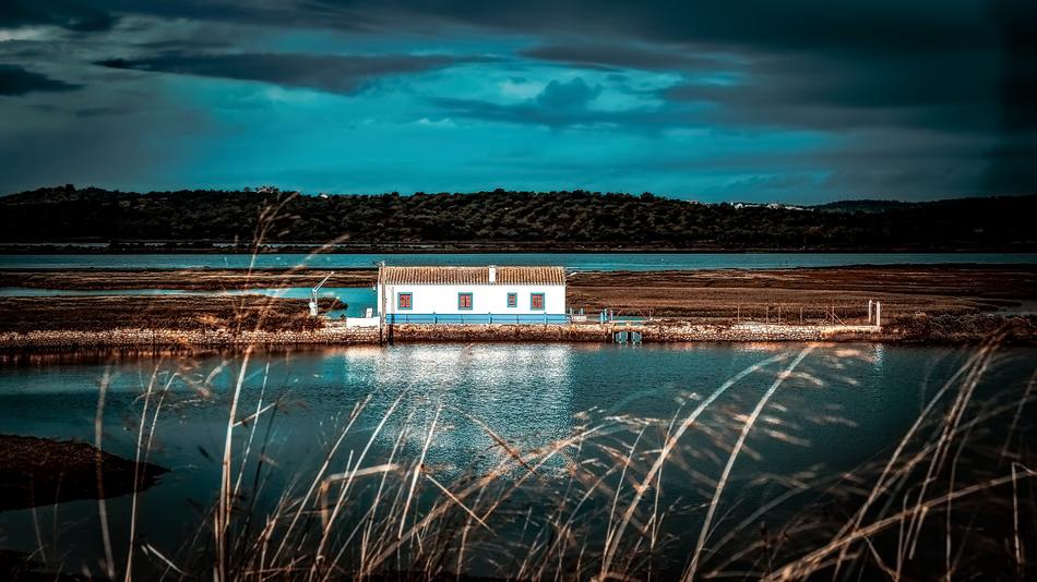 White house, in the beautiful delta of the river, under the beautiful, turquoise sky with the clouds