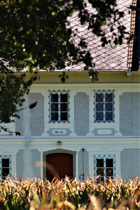 Beautiful and colorful farmhouse, near the plants, in Austria, in sunlight