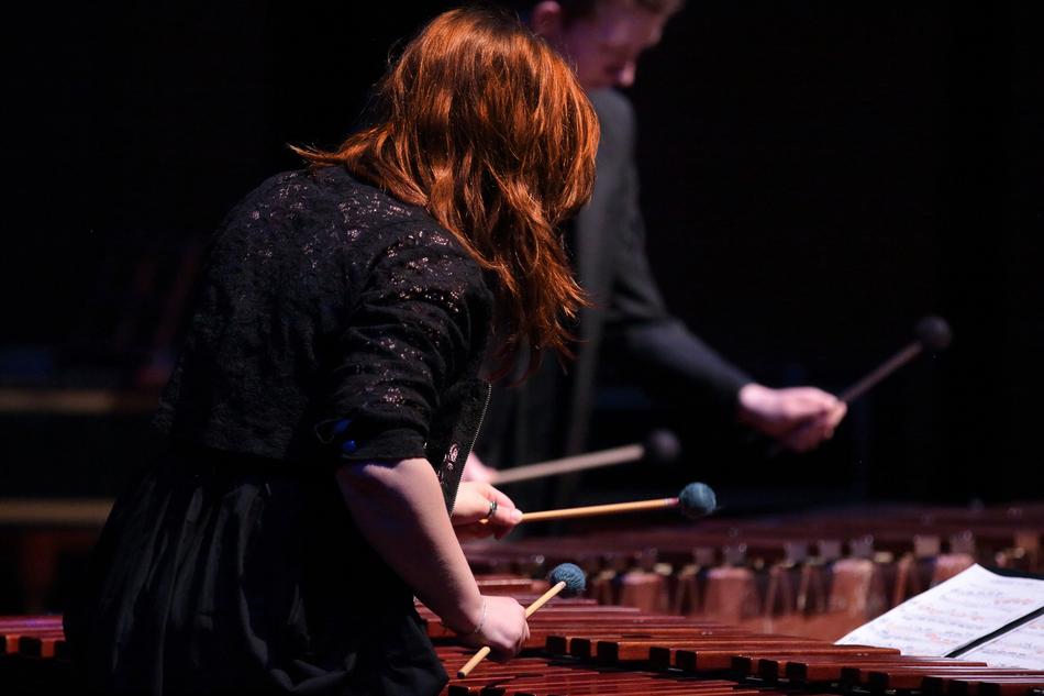 redhead girl plays on marimba