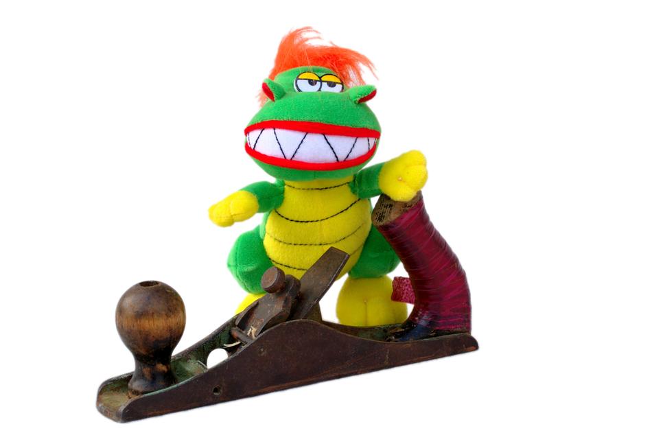 Colorful figure of monster on the wooden construction, at white background, clipart
