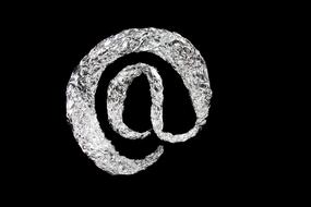 Silver email sign on black background