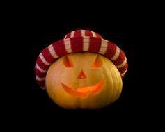 carved pumpkin in a striped hat