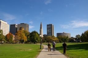 people walking on path through park in Downtown, usa