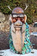 Beautiful and colorful carving of a man in the wood