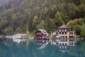 Beautiful and colorful houses, on the shore of the beautiful, turquoise lake, near the colorful trees