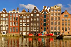 Colorful and beautiful houses, near the canal, with the reflections, in Amsterdam, Netherlands