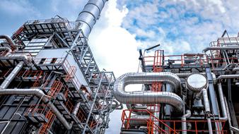 Shiny industrial construction with metal details, under the blue sky with white clouds