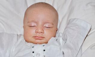 newborn is sleeping sweetly in the crib