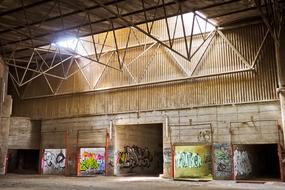 an abandoned factory building with colorful graffiti on the walls