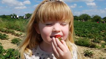 cute baby eats strawberries