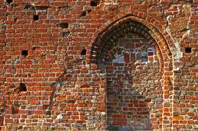 Old brick wall with the arch in Eldena, Germany