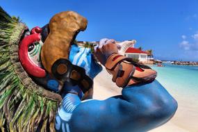 tribal costumed man on beach