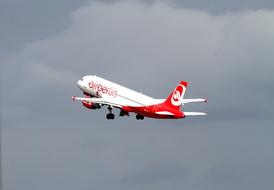 airplane rising in the gray sky