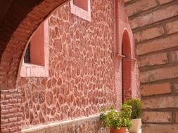 Beautiful passage, near the beautiful house with red masonry and green plants