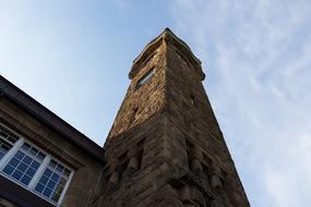 Beautiful, old building in the port of Hamburg, Germany, in light and shadow, under the blue sky with white clouds