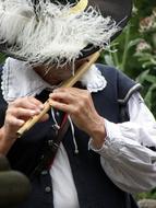 musician in historical costume plays the flute