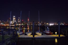 yachts on the hudson river in new york at night