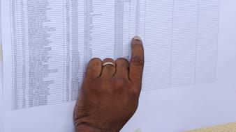 man points his finger at a number