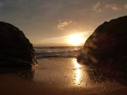 Rocks on Sand beach in Sunset