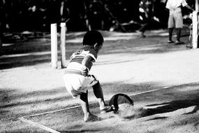 black and white photo of a child outdoors in Indonesia