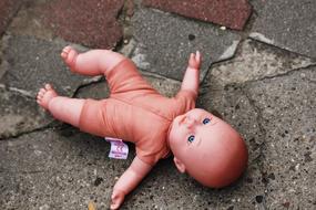 Doll Baby Toy on asphalt