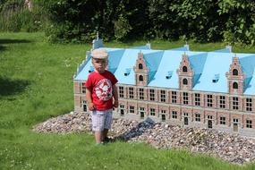 small child boy posing in front of Mini House