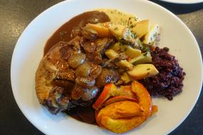 roast meat with vegetables in sauce