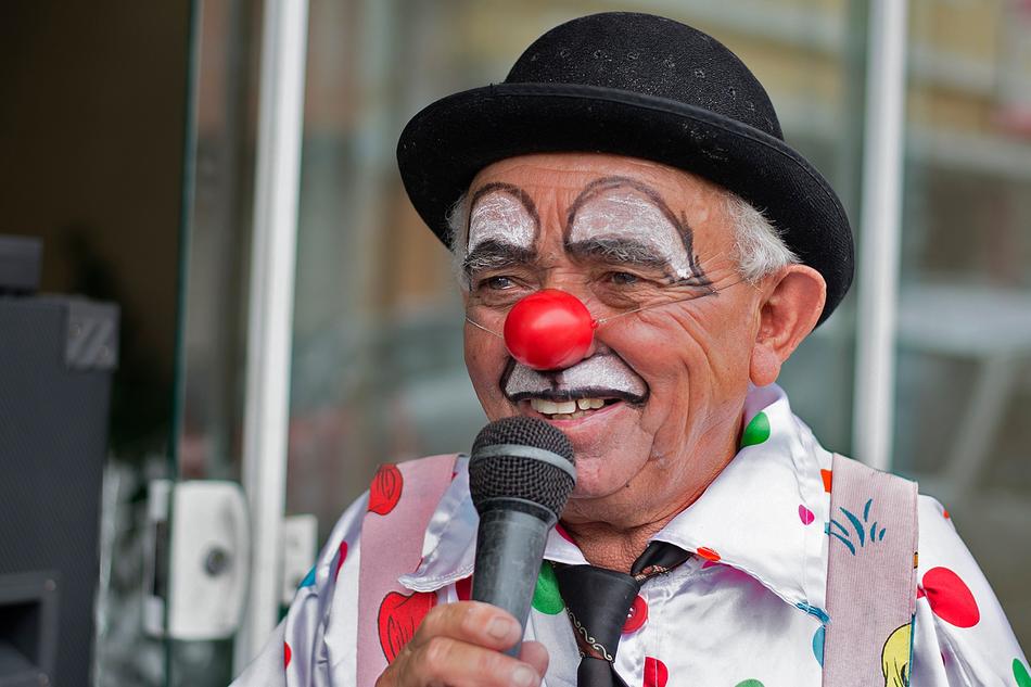 elderly clown with microphone