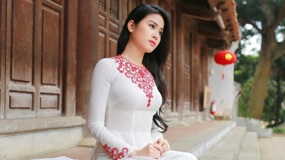 portrait of Nice Asian girl sits on porch in front of traditional building