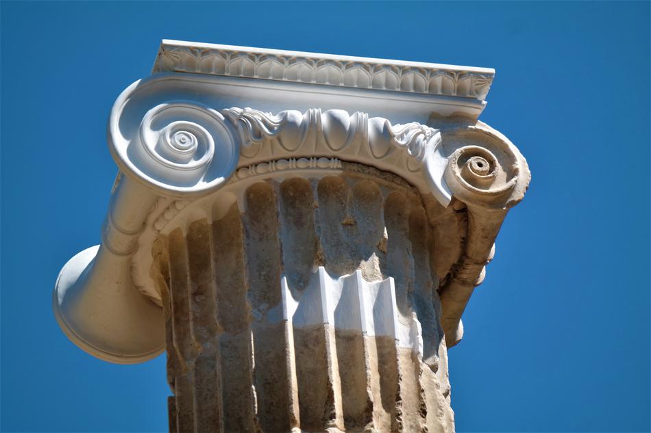 Beautiful, ornamental pillar in Olympia, Greece, under the blue sky