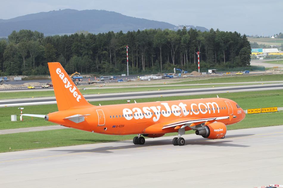 an orange airplane on the line