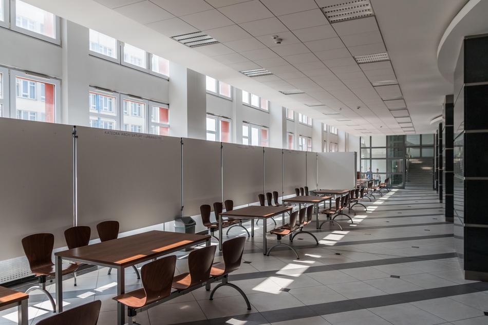 Corridor of the university in Kielce, Poland, with the tables and chairs, and windows with the light
