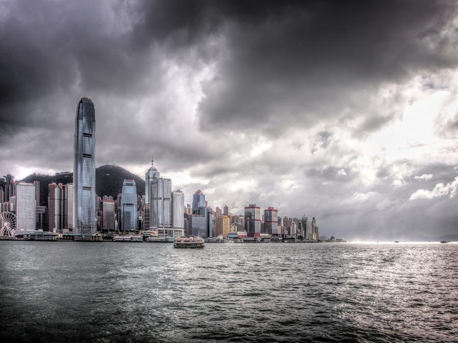 Shore of Hong Kong, with the colorful buildings, under the dark, cloudy ky
